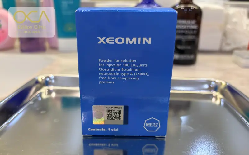 Holographic authenticity seal, QR code and serial number on a sealed Merz Xeomin carton at Edition Clinic Bangkok